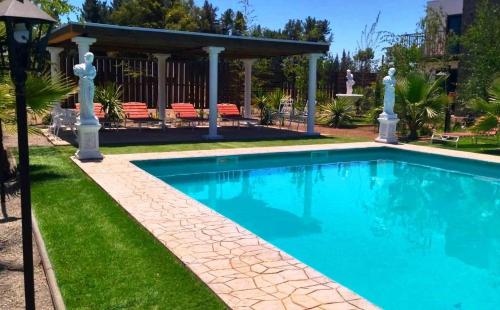 a swimming pool in a yard with a gazebo at Cabañas con Tinaja 10 personas in Quillón