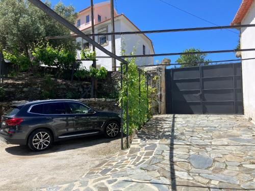 a car parked in front of a driveway at casa das ameias in Folgosa