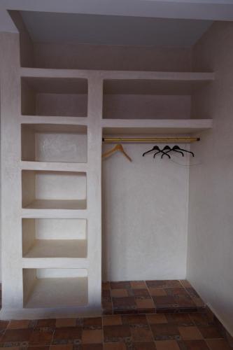 a room with white shelves on the wall at WaveGo Surf Camp in Imsouane