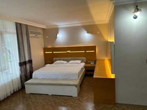 a bedroom with a large bed and a large window at Ayvacık Hotel Restaurant in Samsun