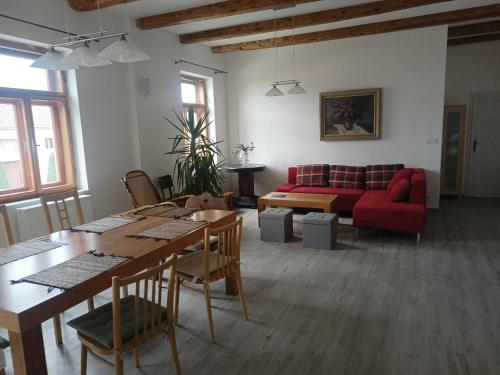 a living room with a red couch and a table at Apartment Odrlice in Senice na Hané