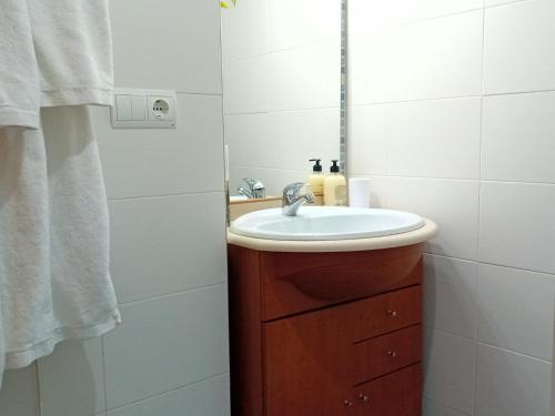 a bathroom with a sink and a mirror at El estudio de las mariposas,sofa cama , cocina y baño in Partida de La Cañada