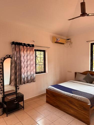 a bedroom with a bed and a window at Sun and Sea, Calangute in Goa