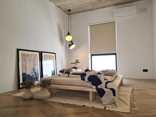 a bedroom with a large bed in a room at Bamboozle Loft in St. Paul's Bay