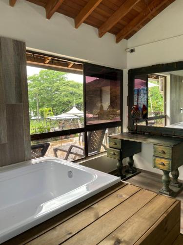 a large bath tub in a room with a large window at Casa Fuego in La Pintada