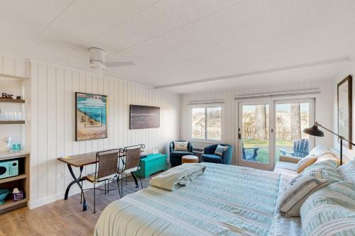 a bedroom with a large bed and a desk at Tall Timber B-2 in Glen Arbor