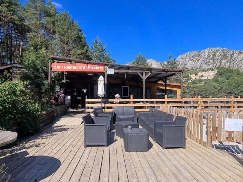 a group of chairs sitting on a wooden deck at Le Nirvâna in Saint-Auban