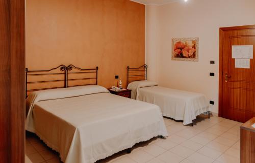 a bedroom with two beds in a room at San Raffaele Hotel Restaurant & Resort in Castelluccio Superiore