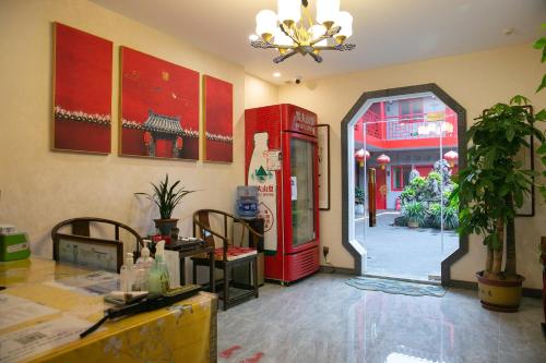 a room with a red refrigerator and a doorway at Rong Hotel - Beijing Nanluoguxiang Branch in Beijing