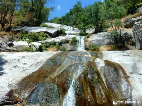 a waterfall in the middle of some rocks at La lechuza blanca in Casavieja