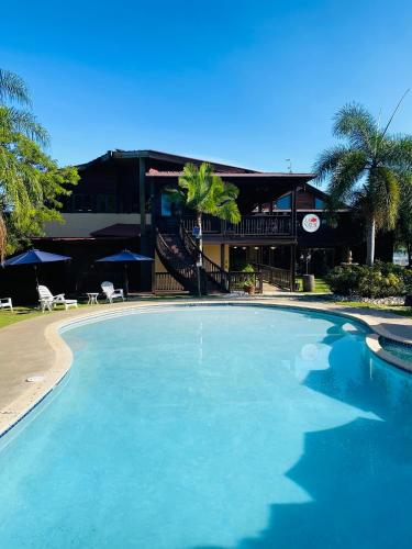 a large swimming pool in front of a building at Hacienda el Jibarito in San Sebastian