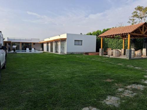 una casa con un patio con césped en Casa de Campo Villa Azul Cañete, en Imperial