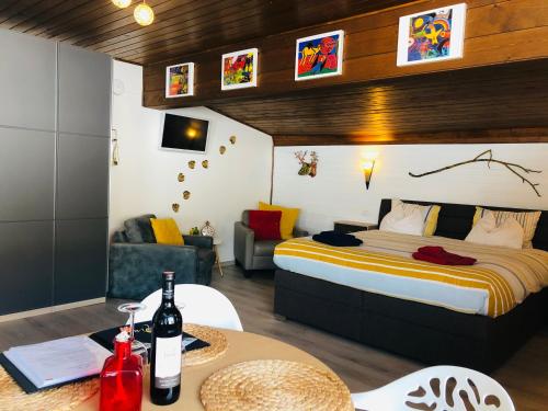 a bedroom with a bed and a table with wine bottles at Schans Appartements in Hermagor