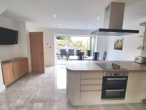 a kitchen with a stove and a counter top at Beautiful countryside cottage, sleeps 6, dogs welcome in Halifax