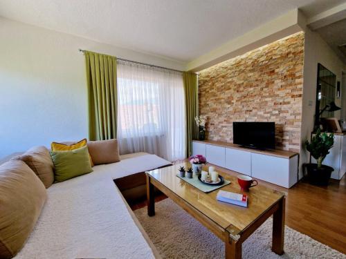 a living room with a couch and a coffee table at Serenity Apartment in Bitola