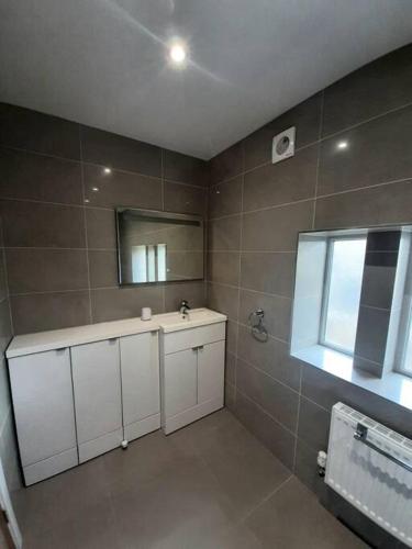 a bathroom with a sink and a mirror at Beautiful countryside cottage, sleeps 6, dogs welcome in Halifax