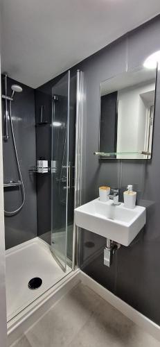 a bathroom with a sink and a shower at The Undercroft - central Leamington in Leamington Spa