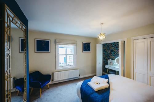 a bedroom with a bed and a chair and a window at Leam Terrace Escape in Leamington Spa