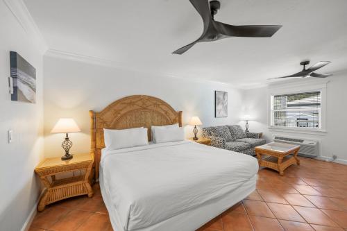 - une chambre avec un grand lit et un canapé dans l'établissement Tropic Isle At Anna Maria Island Inn, à Bradenton Beach