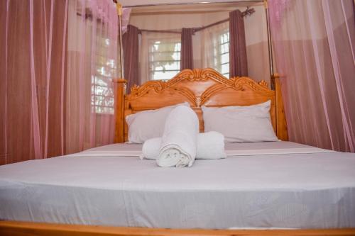 a bedroom with a bed with towels on it at Karura and friends airbnb (affordable) in Ukunda