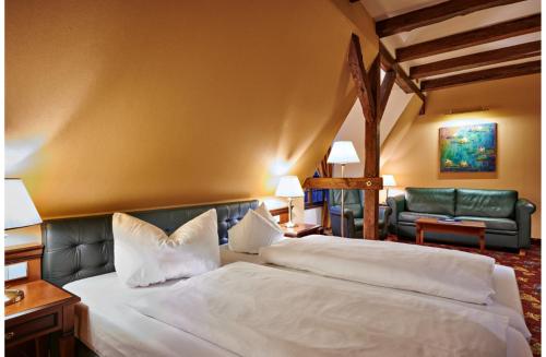 a hotel room with a bed and a couch at Bernsteinschloss in Wendorf