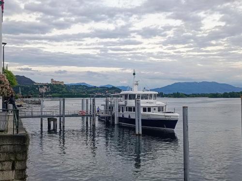 a boat docked at a dock in the water at B&B Lupita in Dormelletto