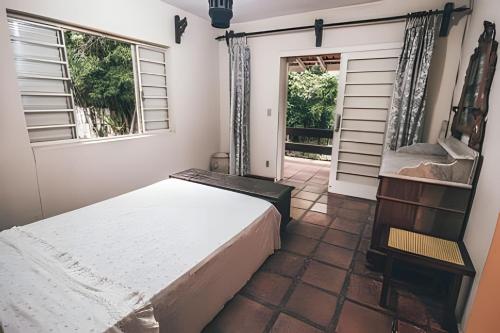 a bedroom with a bed and a window at Sítio em São Roque, paraíso ao lado de São Paulo! in São Roque