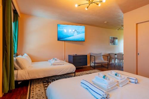 a hotel room with two beds and a flat screen tv at Tropical Breeze in Clearwater Beach