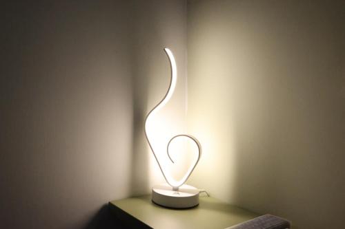 a lighted lamp sitting on a table in a room at Sole apartments in Sarno
