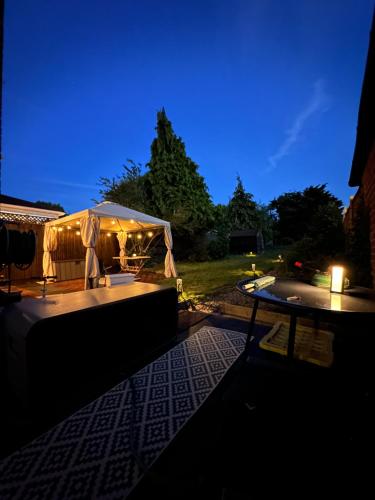a lit up tent on a patio at night at Urban oasis entire house 3 beds 2 living room expansive garden in Eltham