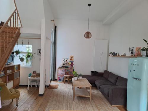 a living room with a couch and a table at Charming house in Ghent in Ghent