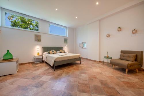 a bedroom with a bed and a couch and a chair at Elenì Sorrento in Sorrento