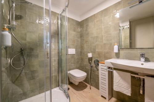 a bathroom with a shower and a toilet and a sink at Elenì Sorrento in Sorrento