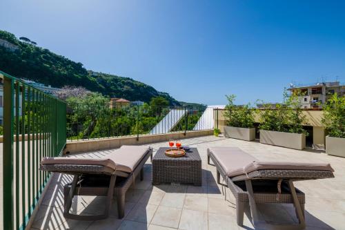 a patio with two chairs and a table at Elenì Sorrento in Sorrento