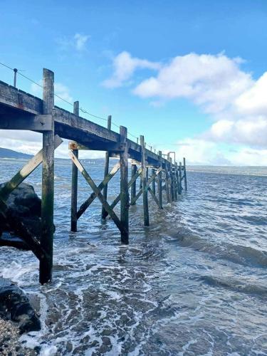 a wooden pier sticking out of the water at Holywood Town House in Town Centre in Holywood