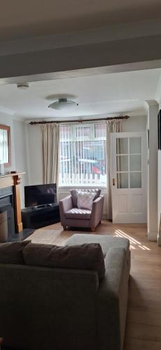 a living room with a couch and a chair at Holywood Town House in Town Centre in Holywood