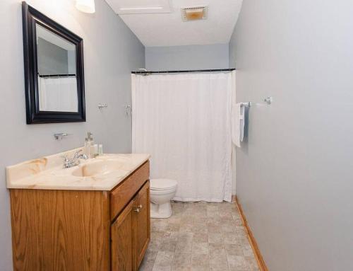 a bathroom with a sink and a toilet and a shower at Kinston Getaway #1 in Kinston