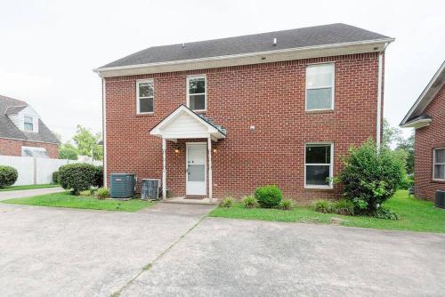 a red brick house with a white door at Kinston Getaway #1 in Kinston