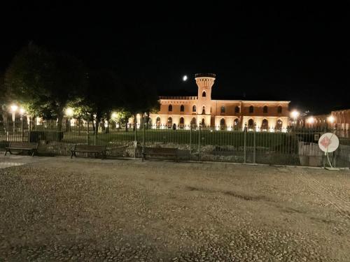 a building at night with benches in front of it at Guest house LangAmore in Bra