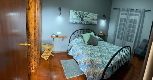 a bedroom with a bed in a room with a door at Casa da Vista- Eirinha in Furnas