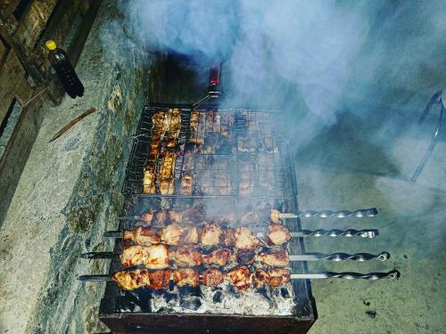 an overhead view of a grill with chickens and meat at Family hotel mountain panorama in Borjomi