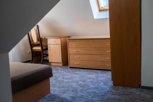 a bedroom with a dresser and a desk with a chair at Palangos Ramybės apartamentai in Palanga