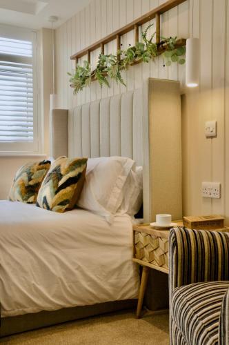 a bedroom with a bed with plants on the wall at The Sunset Nook in Ipswich