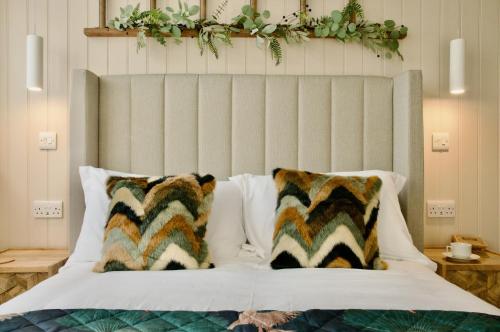 a bedroom with a bed with a large headboard at The Sunset Nook in Ipswich