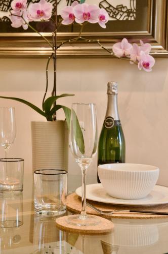 a table with glasses and a bottle of wine at The Sunset Nook in Ipswich
