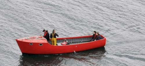 a group of people in a red boat in the water at Horizon View Lodge Bed and Breakfast Glanleam Road Knightstown Valentia Island County Kerry V23 W447 Ireland in Valentia Island