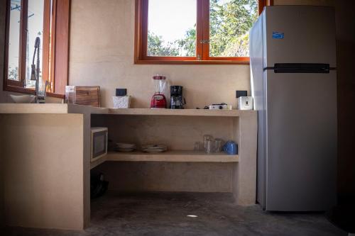 Una cocina con un refrigerador blanco y una ventana. en CASA BERTORIA, en Bacalar
