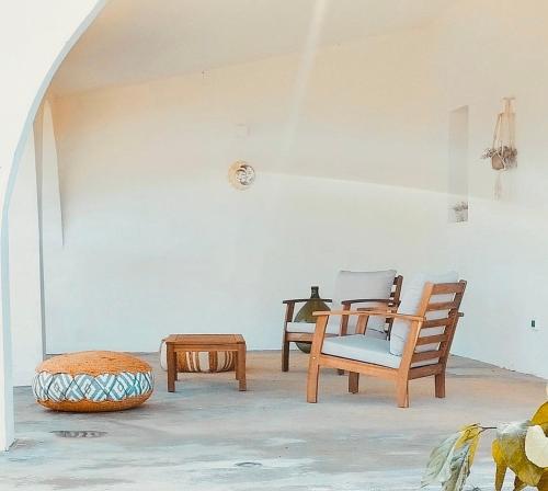 a living room with two chairs and a table at Villa Pupetta Ostuni 4 bedrooms 4 bathrooms - swimming pool in Ostuni