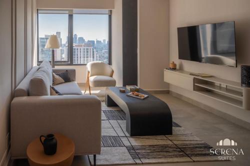 a living room with a couch and a tv at Elegant Condo with Air Conditioning, Pool, Sauna, & Fitness Center in Polanco in Mexico City