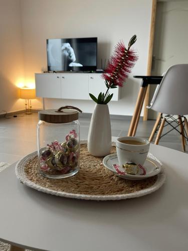 een tafel met een bord eten en een kopje koffie bij Apartments Tijana in Budva